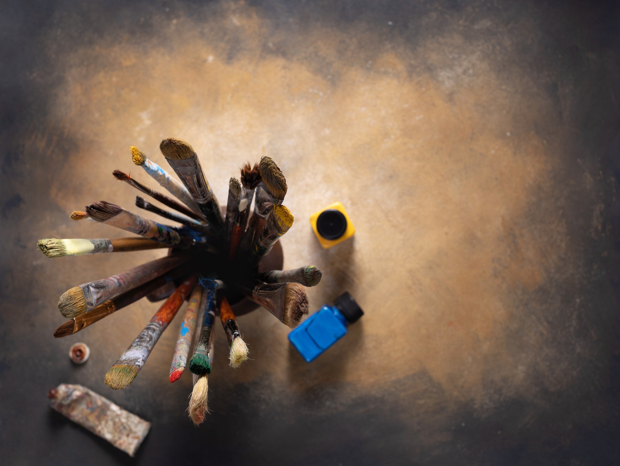 Paint brush in clay jug and art painter tool on abstract background texture. Paintbrush painting