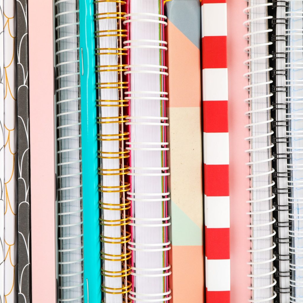 stack-of-colorful-books-and-copybooks-as-background-closeup.jpg